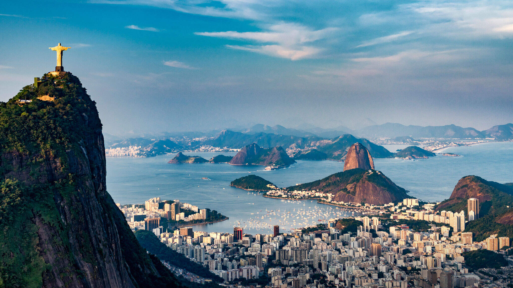 The legendary statue of Christ the Redeemer watches over Rio de Janeiro from the top of Corcovado hill